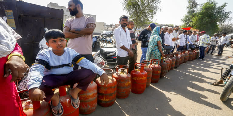 People standing in long queues at Boyinapally gas godown in Hyderabad, waiting to collect LPG cylinders amid shortage ahead of Ramzan.