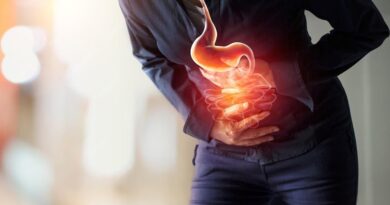 Person suffering from stomach indigestion and abdominal pain after eating
