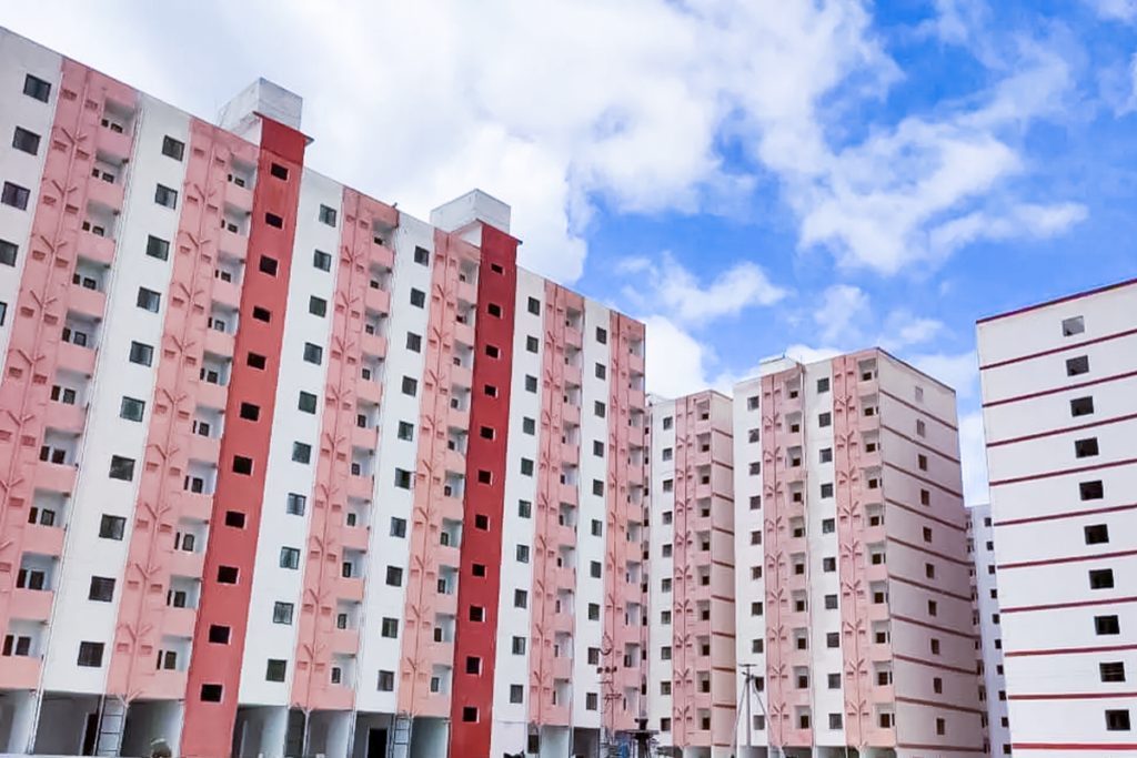 Government-allotted double bedroom flats in Kollur allegedly being sold illegally through notary agreements, with brokers targeting beneficiaries and facilitating unauthorized property deals.