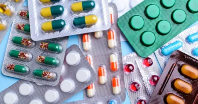 A person holding prescription medicines and pills, highlighting common medication mistakes such as self-medication, skipping doses, stopping antibiotics early, and overusing painkillers.