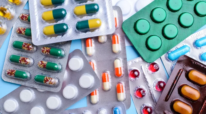 A person holding prescription medicines and pills, highlighting common medication mistakes such as self-medication, skipping doses, stopping antibiotics early, and overusing painkillers.