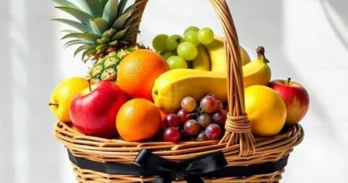 Fresh summer fruits including watermelon, mango, muskmelon, oranges, grapes, bananas, and kiwi arranged on a table for healthy hydration and nutrition.